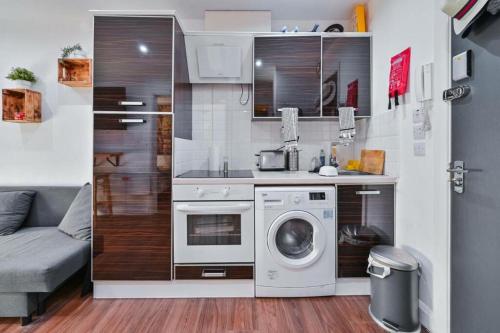 a small kitchen with a washing machine and a washer at Central London Gem: Modern&Cozy in London