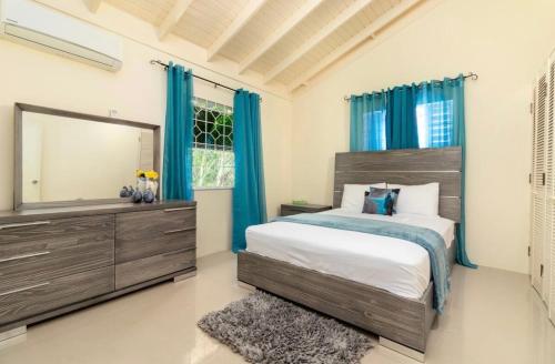 a bedroom with a large bed and a large mirror at Drax Hall Country Club in Mammee Bay