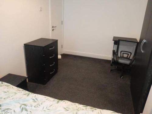 um quarto com uma cama, uma cómoda e uma cadeira em Double-bed (G2) close to Burnley city centre em Burnley