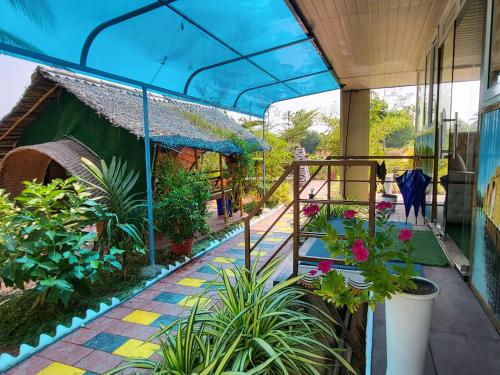 a balcony of a house with plants on it at Bell Farms and Resorts in Munroe Island