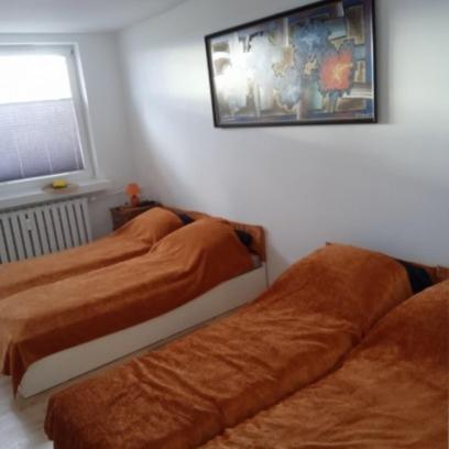 a bedroom with two beds and a window at Hostel Reja 54A in Suwałki