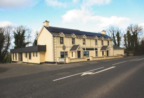 a large white house on the side of a road at The Coach Inn in Strabane