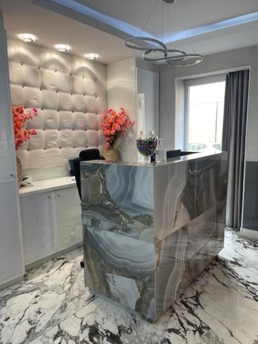 a lobby with a table with a chair on a marble floor at L'Adresse in Paris