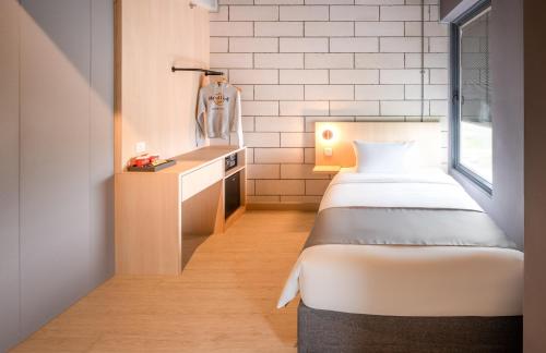 a small room with a bed and a desk at BRIX KLIA By Pinetree in Sepang