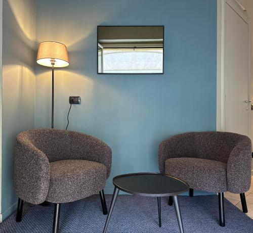 two chairs and a table and a lamp in a room at Hotel Ristorante San Giuseppe in Cernobbio