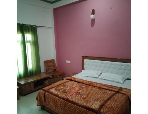 a bedroom with a bed and a purple wall at Ashgrove village resort, Kempty fall in Lakhwār