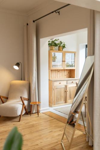 a living room with a easel and a chair at Boho Chic Studio Stellenbosch in Stellenbosch