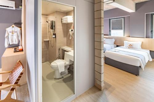 a hotel room with a bed and a bathroom at BRIX KLIA By Pinetree in Sepang