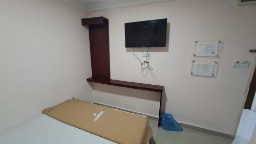 a room with a box and a tv on the wall at SP Venture Boutique Hotel in Rawang