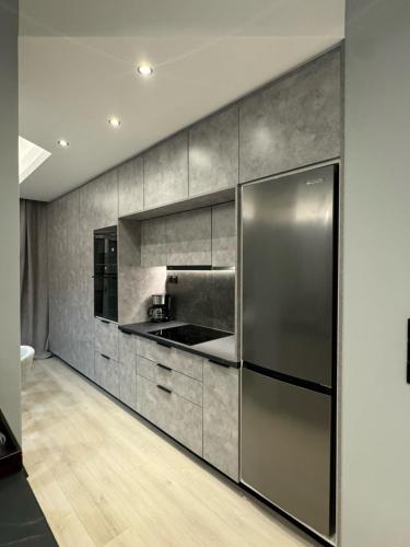 a kitchen with a stainless steel refrigerator at Luxury apartments in athens in Athens