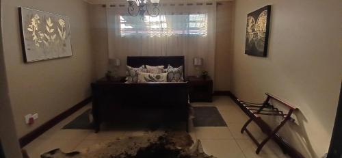 a living room with a couch and a window at Zebra Appartment in Witbank