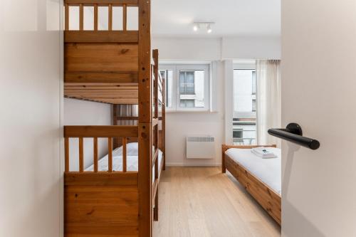 a small room with a bunk bed and a staircase at Ruim en luxueus app met zeezicht én garage - 8p in Knokke-Heist