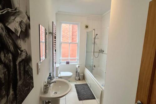 a bathroom with a sink and a toilet and a shower at NEW! Sleeps 4, Wimborne Centre, Parking & Wi-Fi - The Westborough Willows in Wimborne Minster