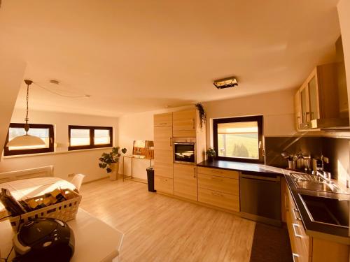 a kitchen with wooden cabinets and a counter top at Ferienwohnung Angelina in Tiefenbach