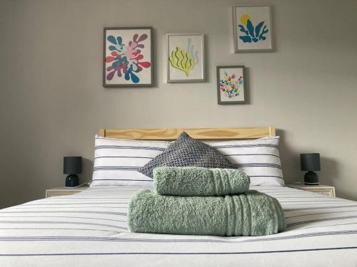 a bedroom with a bed with four pillows on it at Modern home for those on business or on holiday in Newport