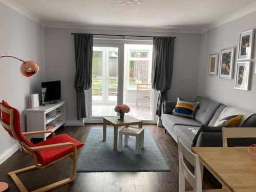 a living room with a couch and a table at Modern home for those on business or on holiday in Newport