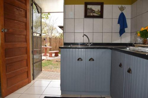 a kitchen with a sink and a counter top at Home away from home. Experience our farm luxury. in Tzaneen