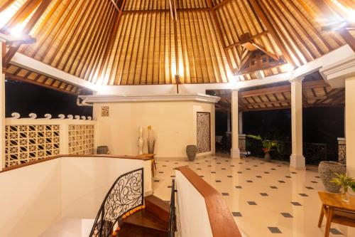 a lobby with a table and chairs and a ceiling at Villa Sky Dancer - Bali in Amed