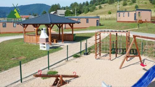 a playground with a swing set and a gazebo at Big Bear Plitvice Nature Resort in Donji Babin Potok