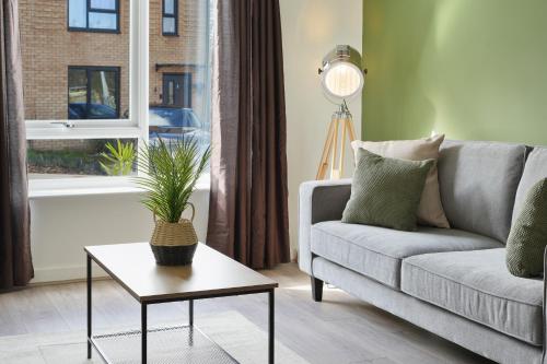 a living room with a couch and a table at Home from Home - Mersey Way, Spacious 3 Bed, Perfect for Workers, Groups & Families, Netflix, FREE Parking & EV Charge Point in Sheffield