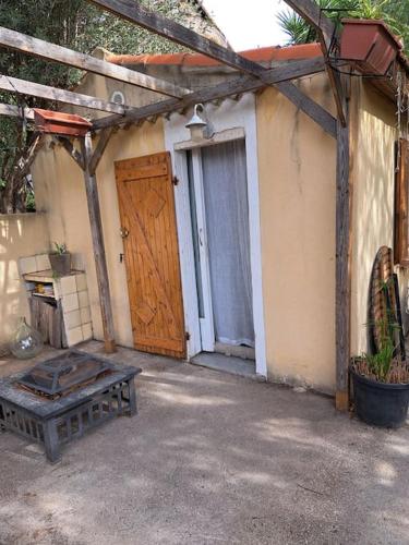 a building with a door and a bench in front of it at Studios sur CARRY le ROUET in Carry-le-Rouet