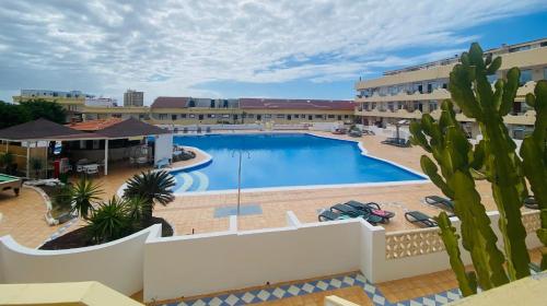 a large swimming pool in front of a building at Beach Paradise Apartment in Adeje