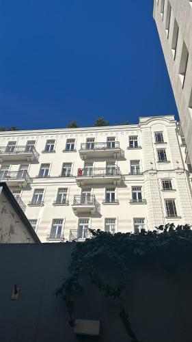 a white building with balconies and a blue sky at Warsaw Concept in Warsaw