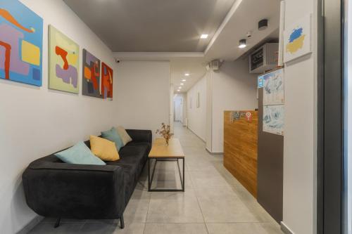 a living room with a black couch and a table at Gogi Resort in Gudauri