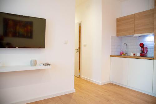 a kitchen with white walls and a counter top at AV Smart Apartment in Pančevo
