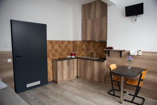 a kitchen with a table and a small kitchen with a sink at Noclegi "Poza Szlakiem" in Wałbrzych