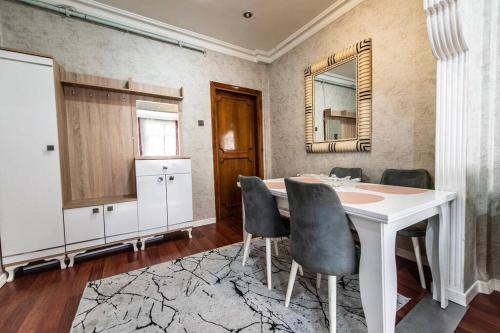 a dining room with a table and chairs and a mirror at Best Location-Taksim Square Big and Modern Flat 140 (m2) 2+1 in Istanbul