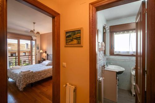 a bedroom with a bed and a sink and a mirror at Vivienda Vacacional Eltxok in Llanes