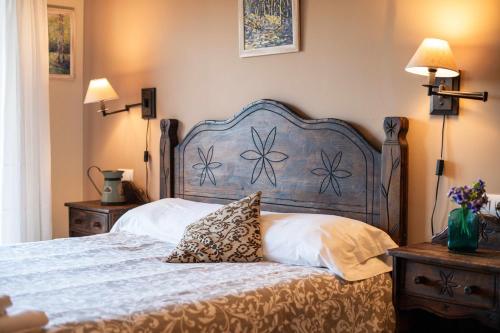 a bedroom with a large bed with a blue headboard at Vivienda Vacacional Eltxok in Llanes