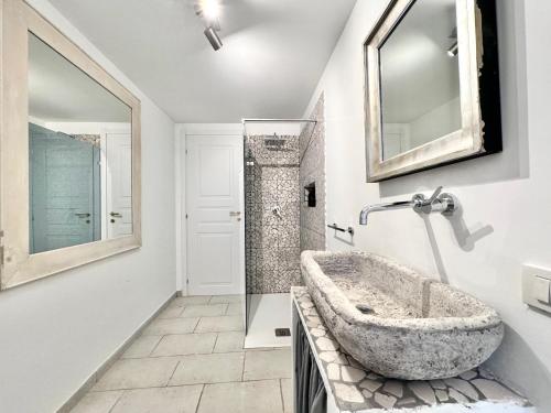a bathroom with a stone sink and a mirror at ComeCasa Langhe Garden House-Pace e Panorama a Benevello in Benevello