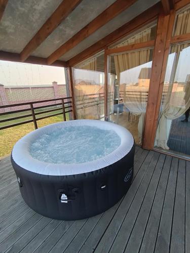 a large hot tub sitting on a deck at Scandidim Lutsk in Luts'k