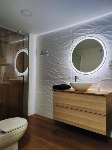 a bathroom with a sink and a mirror at Sea you soon apartment. Lloret de Mar city center in Lloret de Mar