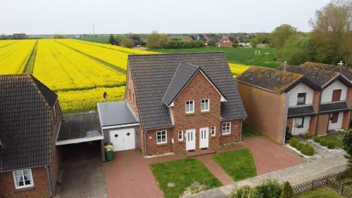 an aerial view of a house in front of a field at Haus im Halligweg 20 in Nordstrand