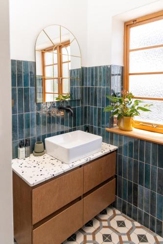 a bathroom with a sink and a mirror at Boho Chic Studio Stellenbosch in Stellenbosch