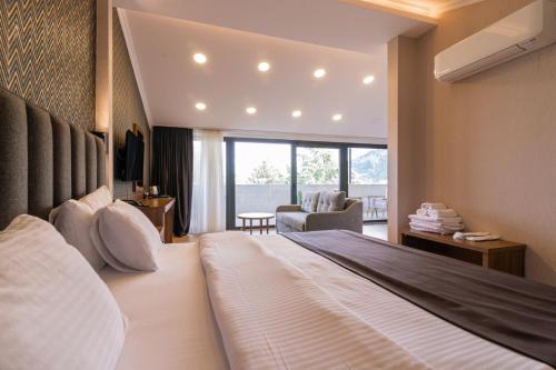 a bedroom with a large bed and a living room at EÖB TAKSİM HOTEL in Trabzon