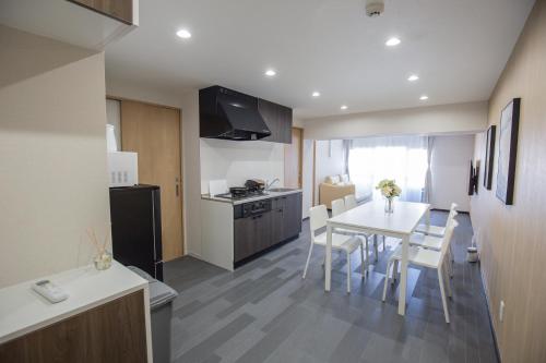 a kitchen and dining room with a table and chairs at 1min walk to Higashi Shinjuku sta 8PPL Shinjuku Gyoen丶 National Garden丶 Kabukicho丶 Shinjuku Station丶 Golden Gai丶 Tokyo Metropolitan Government Building YYoQA in Tokyo
