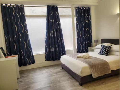 a bedroom with a bed and a large window at 2bed2 bath flat soho in London