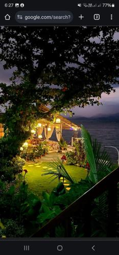 a picture of a garden with a view of the ocean at Chue&larry's Beachside Homestay in Libagon