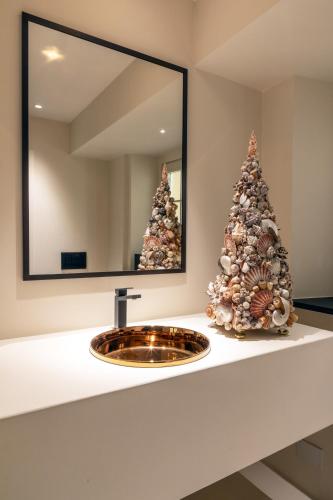 a bathroom with a sink and two christmas trees at Hotel Palazzo Durazzo Suites in Genova