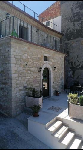 a brick building with an archway and a balcony at B&B Celeste - Palazzo D'Addario in Celenza Valfortore