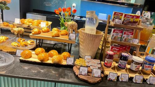 a bakery with a bunch of pastries on a counter at lyf Sukhumvit 8 Bangkok in Bangkok