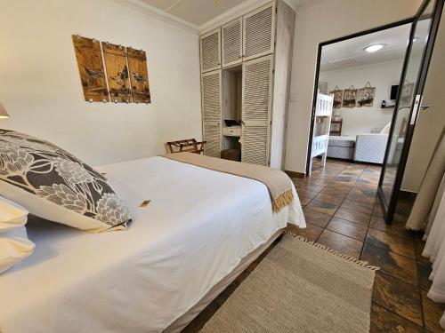 a bedroom with a large bed and a living room at Leopard Corner Lodge in St Lucia