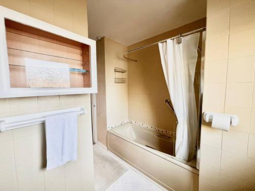a bathroom with a shower and a bath tub at Pass the Keys Cosy Flat in Maritime Quarter in Swansea