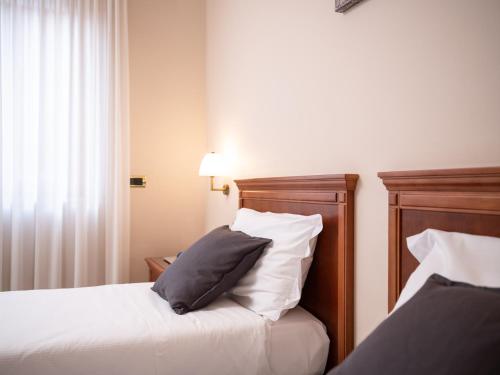 a hotel room with two beds with pillows at Hotel SAN PIO in San Giovanni Rotondo