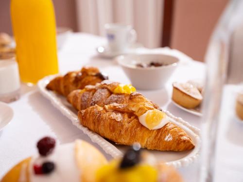 a table with two pastries on a table at Hotel SAN PIO in San Giovanni Rotondo