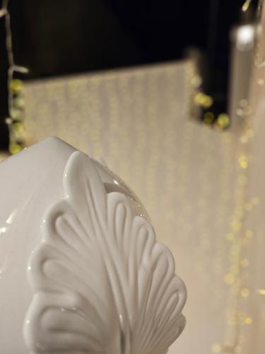 a white plate with a flower on top of it at Vecchia Mottola Private Suite & Spa in Mottola